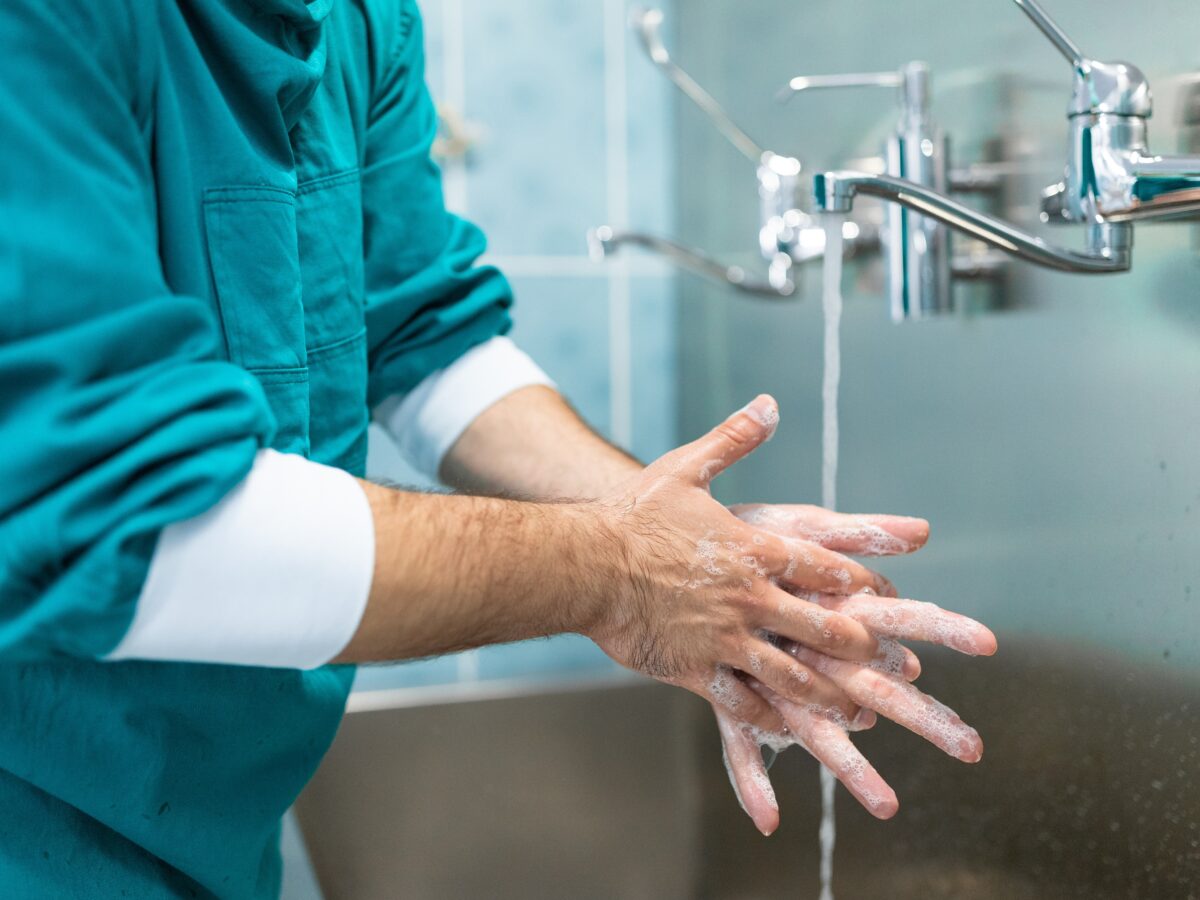 Closeup,Photo,Of,Male,Hands,With,Soap,Under,Running,Water.